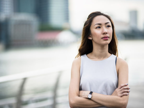 pretty asian woman standing outdoors
