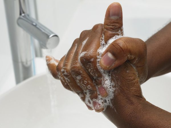 An African American hand washing. Part of Surgical Scrub Technique for Hand Decontamination